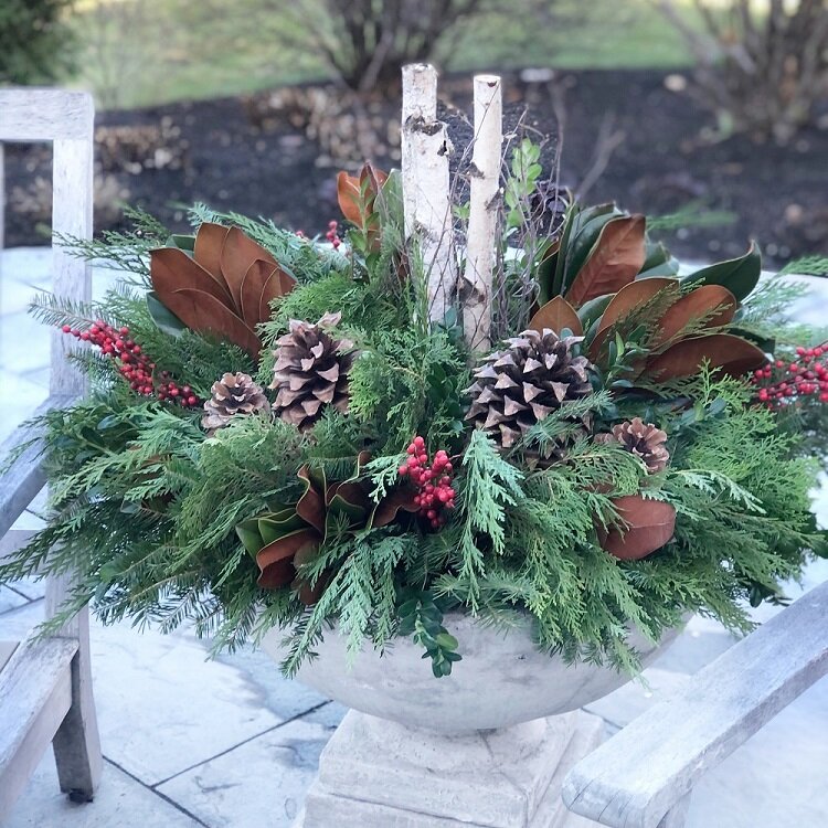 centerpeice with green pine, cones and candles