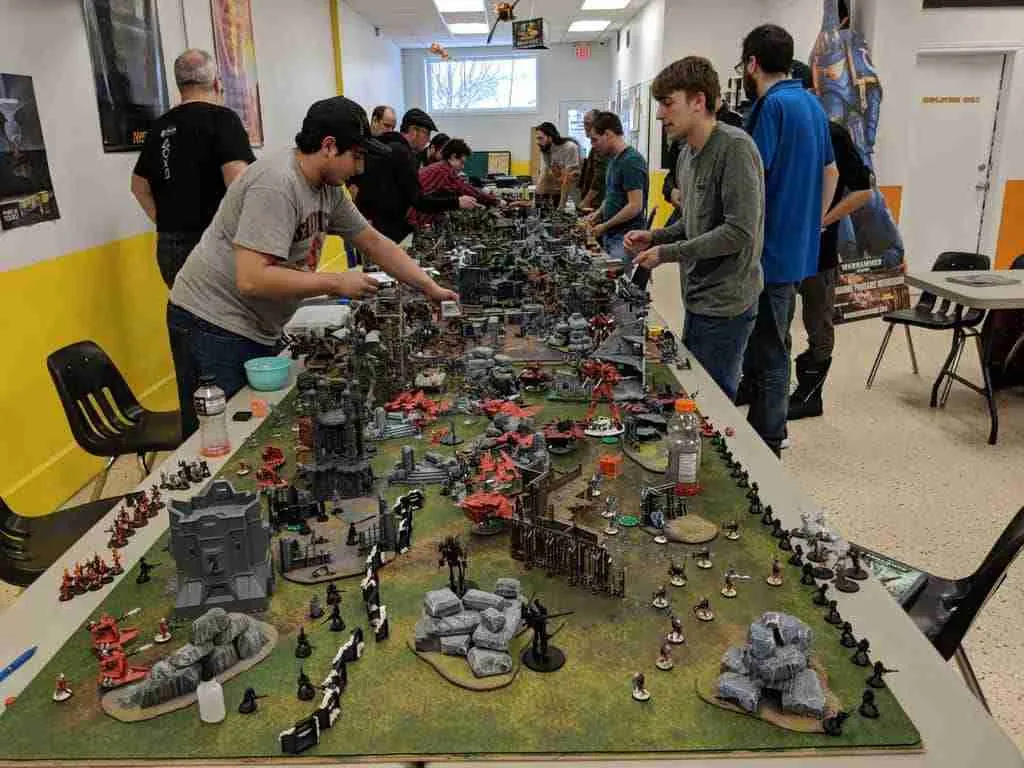 People playing war game on tabletop diarama