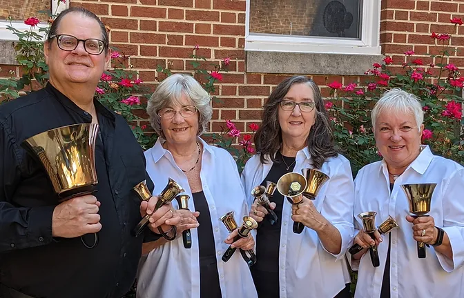 Members of quartet holding bells
