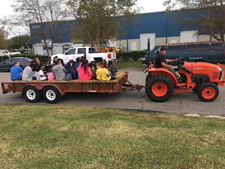 haywagon pulled by tractor with people riding