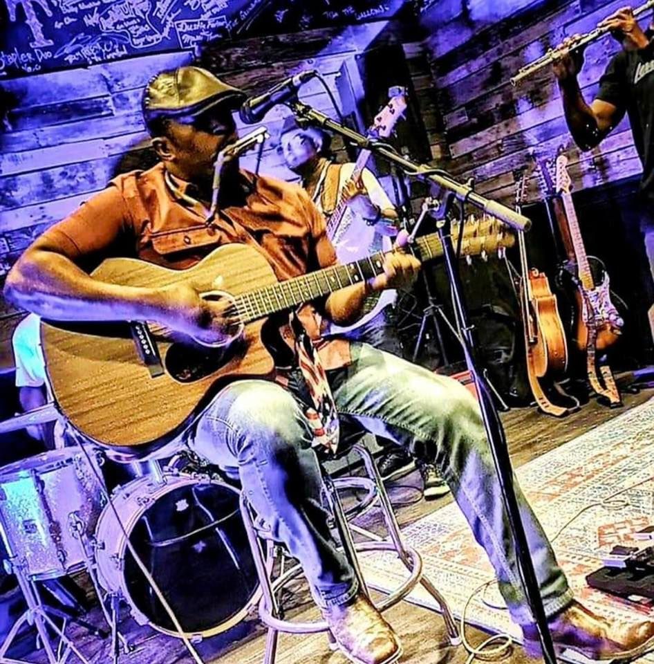 Horseboy playing guitar and harmonica