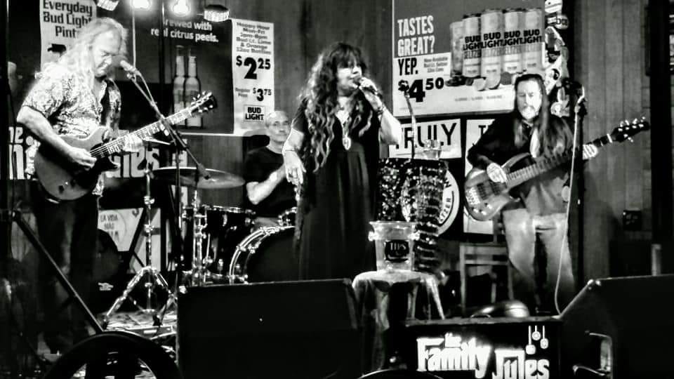 Band on stage with female singer, guitar,bass and drums