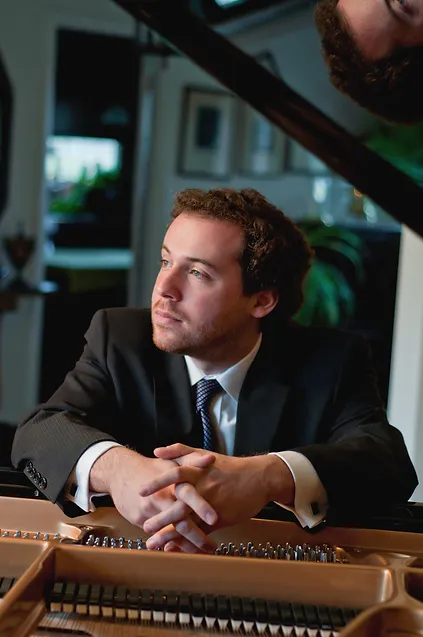 Solomon Eichner sitting at piano