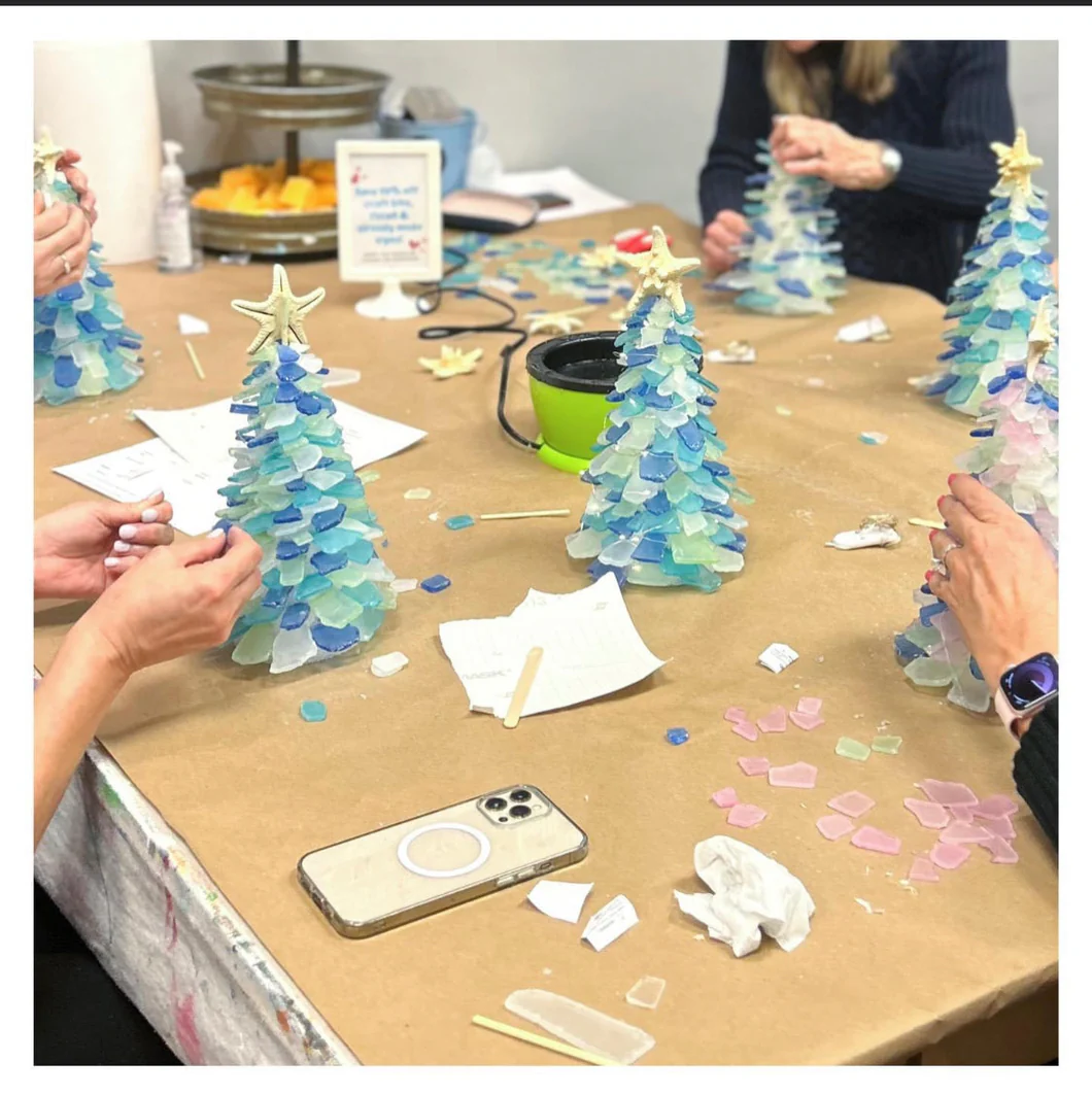 Craft table with people making sea glass trees