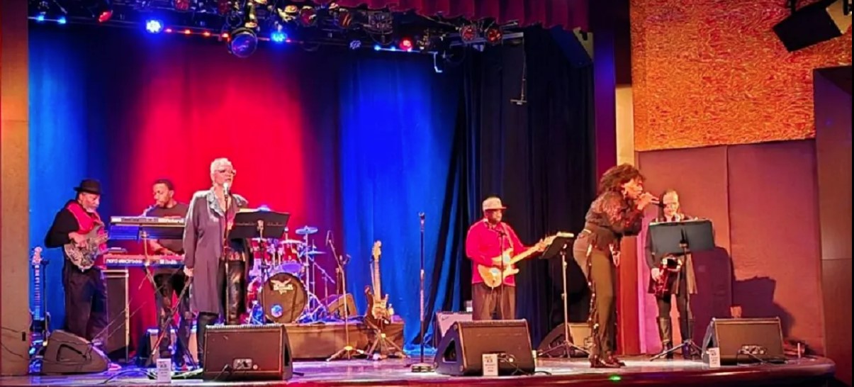 Band on stage with colorful lights