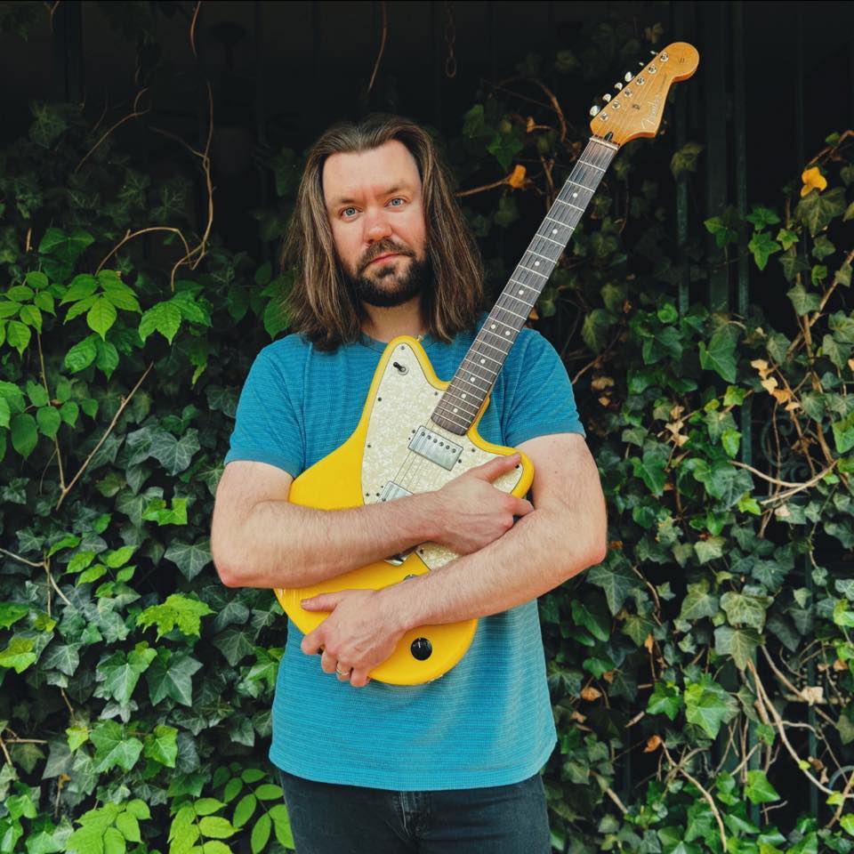 Allen Hudson holding electric guitar