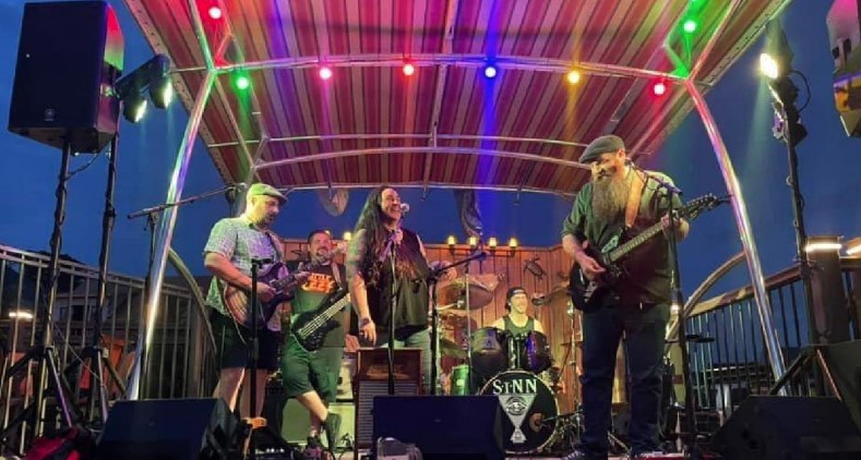 Lori Creek band members on stage with colorful lights